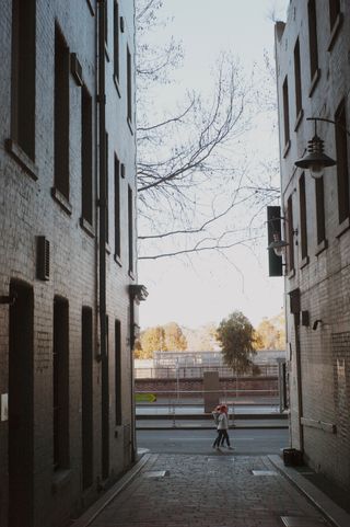 Children walking past the alleyway in front of Bowery to Williamsburg in Oliver Lane.