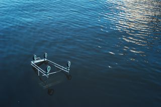 An upside down shopping trolly floating in the Yarra River.