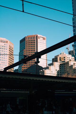 A view of the sky and distant buildings from the platform of Flinders Street Railway Station.